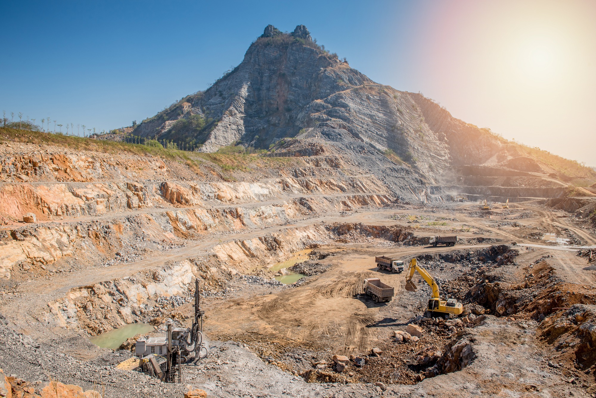 Opencast mining quarry with lots of machinery at work